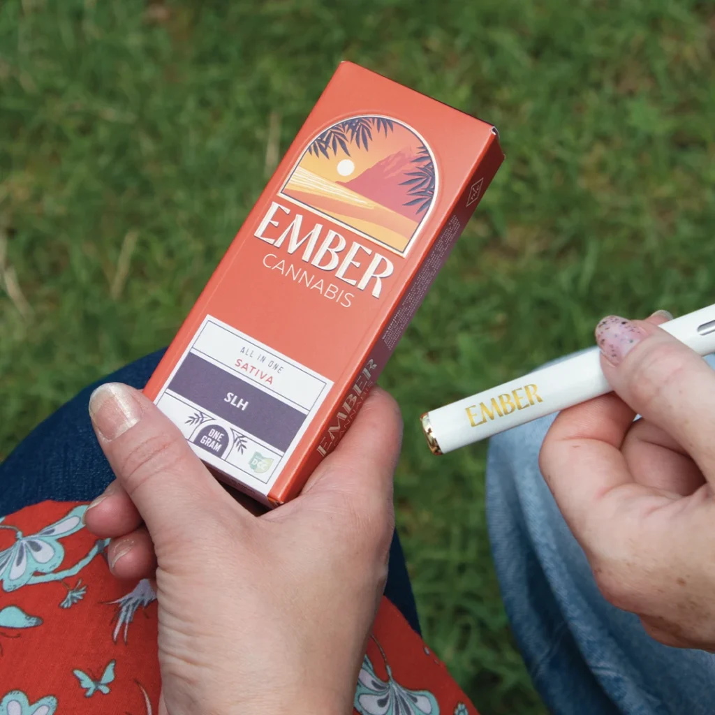 Hands holding an Ember all in one device and box